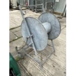 A VINTAGE GALVANISED CABLE REEL ON WHEELS