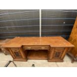 A VICTORIAN POLLARD OAK BREAKFRONT SIDEBOARD WITH CARVED PANEL DOORS AND THREE INTERNAL SLIDES,