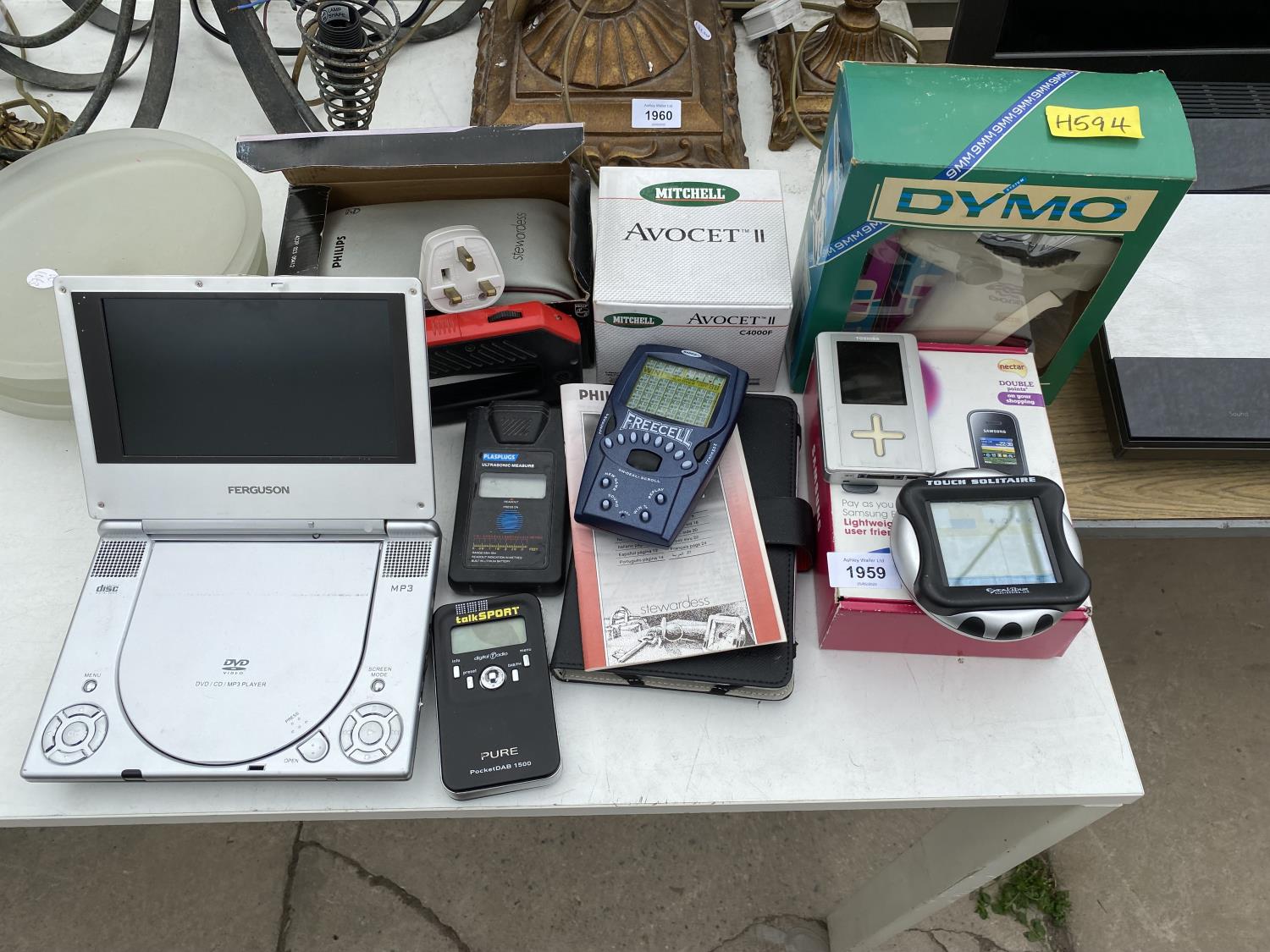 AN ASSORTMENT OF ITEMS TO INCLUDE A PORTABLE DVD PLAYER, RADIOS AND GAMES ETC