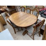 AN OAK EXTENDING DINING TABLE AND SIX CHAIRS