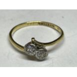 AN 18 CARAT GOLD AND PLATINUM RING WITH TWO DIAMONDS ON A TWIST SIZE N IN A PRESENTATION BOX