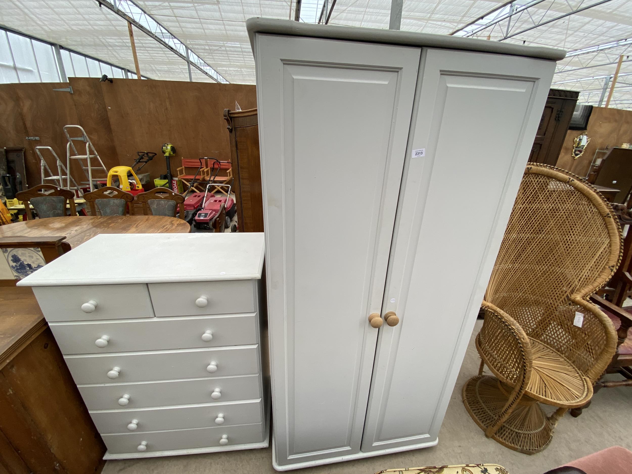 A MODERN TWO-DOOR PAINTED WARDROBE AND CHEST OF DRAWERS