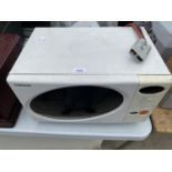 A WHITE SAMSUNG MICROWAVE OVEN