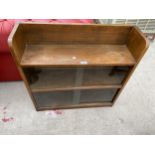 AN OAK BOOKCASE WITH FOUR SLIDING GLASS DOORS AND OPEN TOP SECTION, 30" WIDE