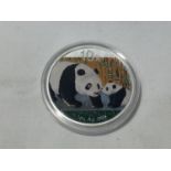 A SILVER 2011 1OZ COIN AG .999 WITH PANDA AND CUB DECORATION CAPSULATED