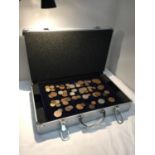 A HARD METAL CASE CONTAINING COIN TRAYS AND VARIOUS COINS INCLUDING TWO VICTORIAN SHILLINGS, A