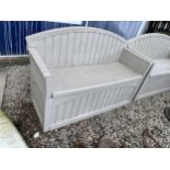 A PLASTIC SUNCAST GARDEN BENCH WITH UNDER SEAT STORAGE