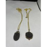 TWO BLACK BASAULT PENDANTS ON CHAINS IN A PRESENTATION BOX