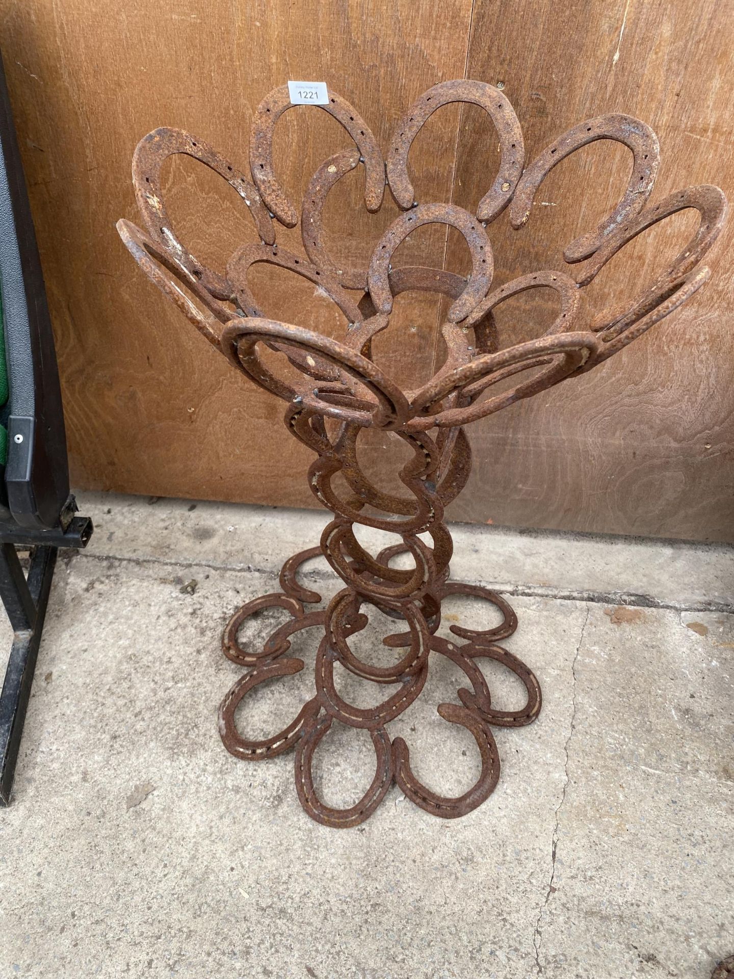 A DECORATIVE PLANTER FORMED FROM HORSE SHOES