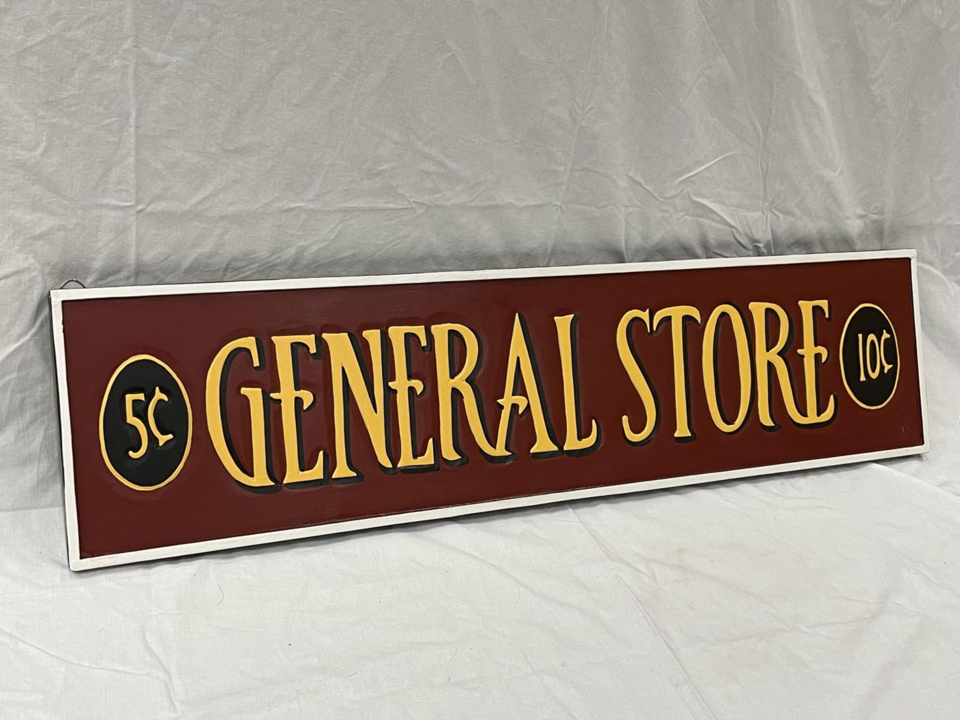 A WOODEN PAINTED GENERAL STORE SIGN 100CM X 25CM