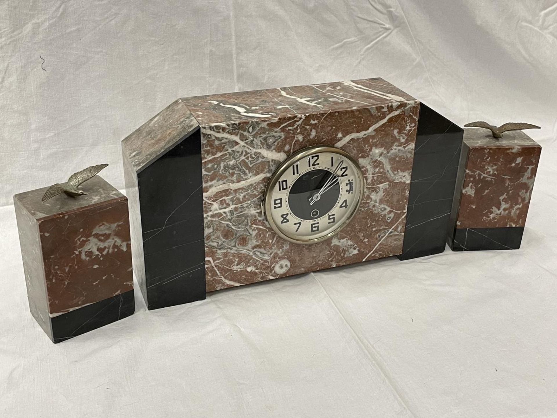 A MARBLE CLOCK WITH GARNITURES IN AN ART DECO STYLE