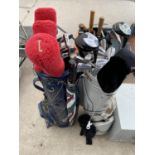 TWO GOLF BAGS CONTAINING AN ASSORTMENT OF GOLF CLUBS AND A FURTHER GOLF BAG