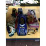 AN ASSORTMENT OF TOYS TO INCLUDE SUBARU RC CAR, BATMOBILE, IRON MAN MASK, BARBIE VIOLIN ETC.