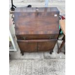 A MID 20TH CENTURY MAHOGANY AND CROSSBANDED BUREAU ON CABRIOLE LEGS, 29" WIDE