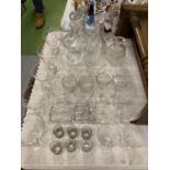 A QUANTITY OF GLASSWARE TO INCLUDE DECANTERS, WINE, SHERRY, SHOT GLASSES, ETC