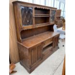 AN OAK LINENFOLD DRESSER COMPLETE WITH RACK, 63" WIDE, LACKING DRAWERS