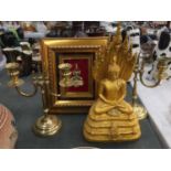 A GOLD COLOURED FIGURE OF A DEITY AND A FRAMED 3D DEITY PLUS A PAIR OF BRASS CANDLESTICKS