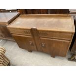 AN EARLY 20TH CENTURY OAK SIDEBOARD ENCLOSING TWO CUPBOARDS AND TWO DRAWERS, 48" WIDE