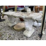 A RECONSTITUTED STONE BENCH WITH SQUIRREL PEDESTAL BASES