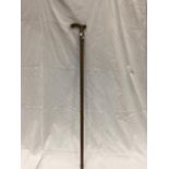 A WOODEN WALKING CANE WITH A BRASS HANDLE