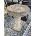 A RECONSTITUTED STONE BIRD BATH WITH PEDESTAL BASE