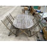 A TEAK GARDEN PATIO SET TO INCLUDE A TABLE AND FOUR CHAIRS AND A FURTHER DECK CHAIR