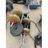 A WEIGHT LIFTING BAR AND WEIGHTS, BUMB BELLS AND WHEELS ETC