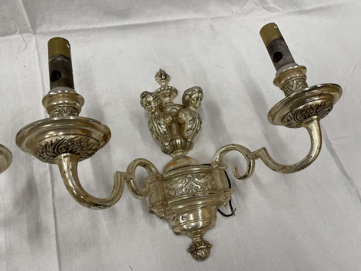 A PAIR OF WHITE METAL DOUBLE WALL LIGHTS WITH CHERUB STYLE DESIGN - Image 3 of 4