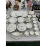 A BONE CHINA WEDGWOOD DINNER SERVICE IN THE 'WESTBURY' PATTERN TO INCLUDE PLATES, BOWLS, TUREENS,