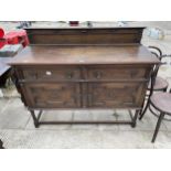 AN EARLY 20TH CENTURY OAK SIDEBOARD WITH RAISED BACK, ON TURNED LEGS