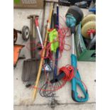 AN ASSORTMENT OF GARDEN TOOLS TO INCLUDE A SPADE, A FORK AND A GRASS STRIMMER ETC