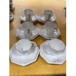 A SET OF SIX WEDGWOOD CHINA TRIOS IN WHITE. THE PIECES ARE OCTAGONAL IN SHAPE WITH THE CUPS HAVING A