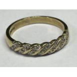 A 9 CARAT GOLD RING WITH SMALL DIAMONDS IN A TWIST DESIGN SIZE O