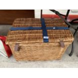 A WICKER PICNIC HAMPER BASKET