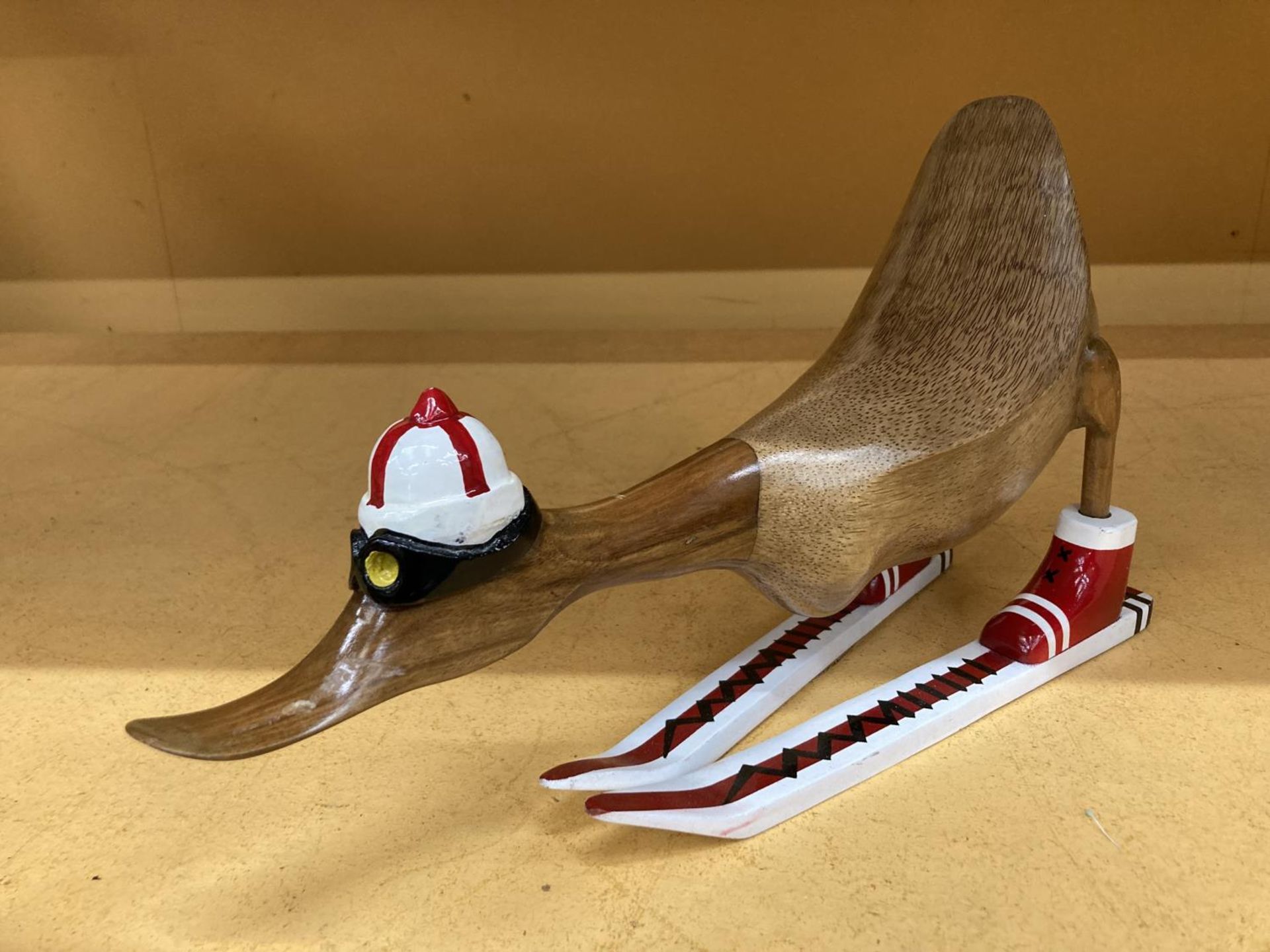 A MODEL OF A WOODEN DUCK ON SKIS LENGTH APPROX 43CM, HEIGHT 24CM