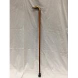 A WOODEN WALKING CANE WITH A DUCK HEAD BRASS HANDLE