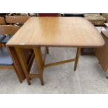 A RETRO TEAK DROP-LEAF DINING TABLE