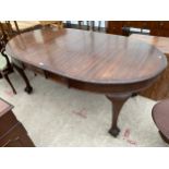 A MID 20TH CENTURY MAHOGANY WIND-OUT DINING TABLE ON CABRIOLE LEGS WITH BALL AND CLAW FEET,