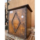 A VINTAGE MINITURE OAK SMOKERS CABINET WITH A PIPE AND A CLAY POT