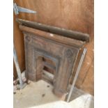 A LARGE DECORATIVE CAST IRON FIRE PLACE WITH MANTLE SHELF