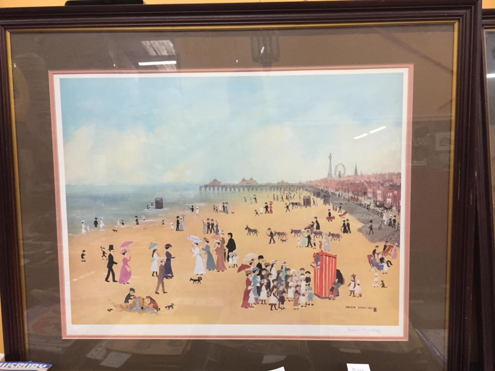 A FRAMED SIGNED HELEN BRADLEY PRINT TITLED 'BLACKPOOL SANDS WITH PUNCH AND JUDY SHOW' 84CM X 70CM