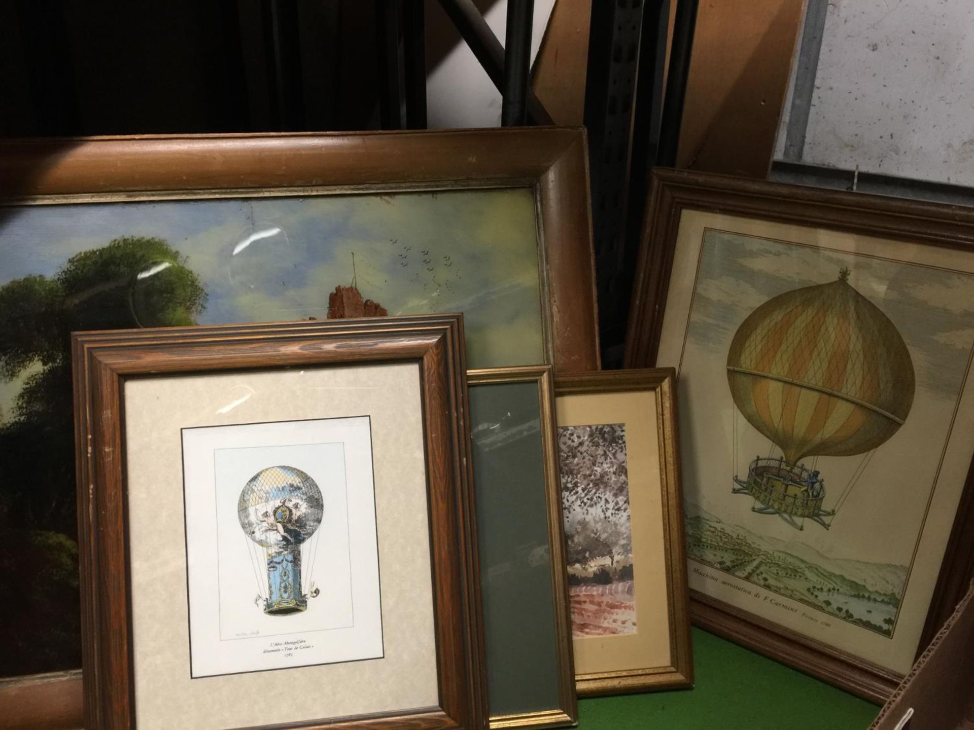 A FRAMED PAINTING OF A CASTLE ON GLASS, TWO FRAMED BALLOON PRINTS, A STREET SCENE AND A CHURCH