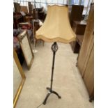 A BLACK CAST METAL STANDARD LAMP WITH SHADE