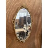 A DECORATIVE GILT FRAMED WALL MIRROR