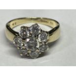 A 9 CARAT GOLD RING WITH EIGHT CUBIC ZIRCONIA STONES IN A FLOWER DESIGN SIZE O