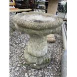 A RECONSTITUTED STONE BIRD BATH WITH PEDESTAL BASE
