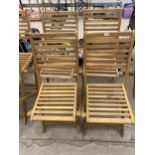 A SET OF FOUR BRAND NEW TEAK FOLDING GARDEN CHAIRS