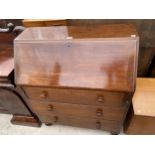 A 19TH CENTURY MAHOGANY BUREAU WITH FITTED INTERIOR OVER THREE GRADUATED DRAWERS, 36" WIDE