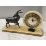 A MARBLE CIRCULAR CLOCK ON A MARBLE BASE WITH A METAL GAZELLE DECORATION BASE 40CM X 10CM