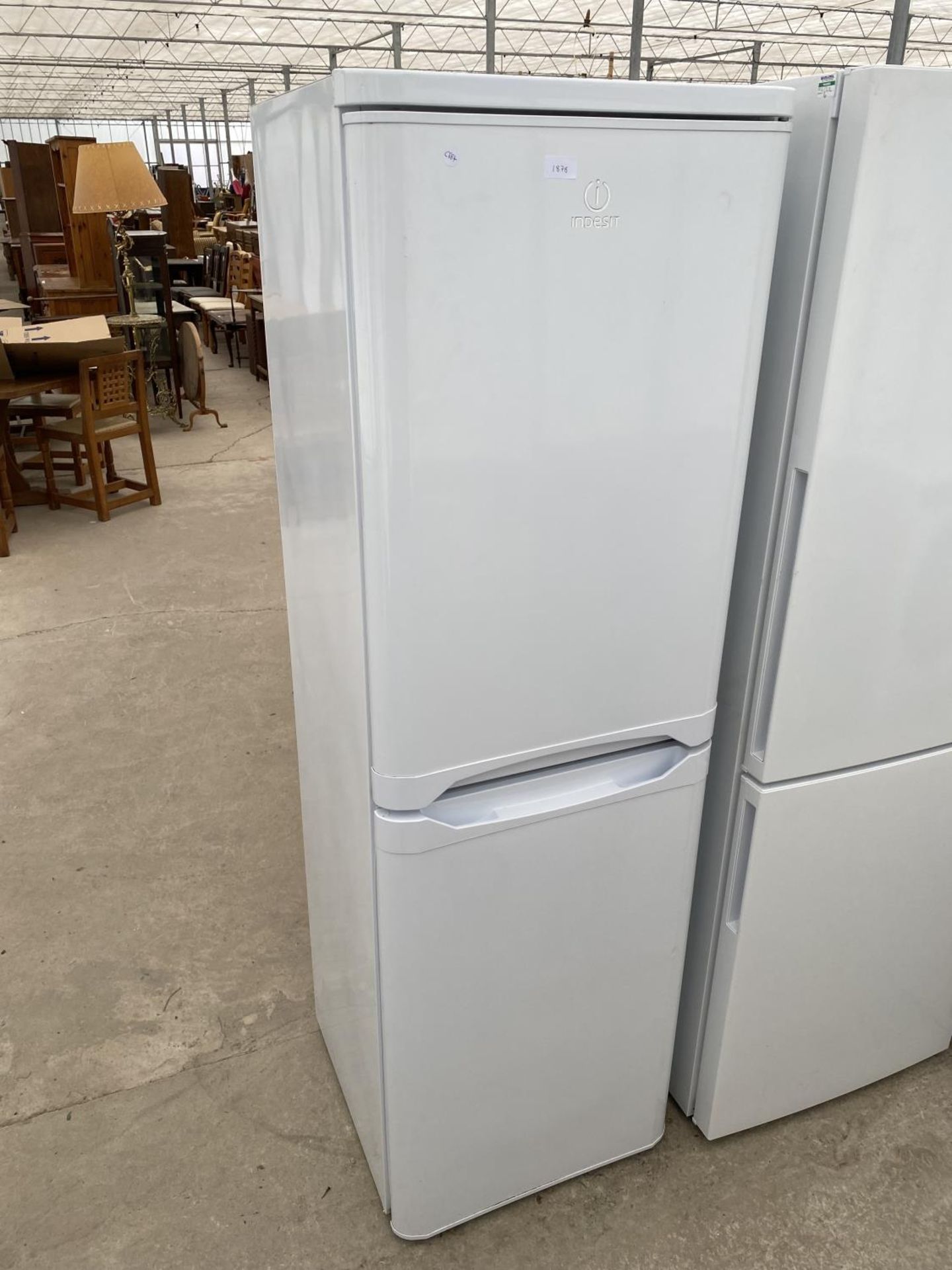 A WHITE INDESIT UPRIGHT FRIDGE FREEZER